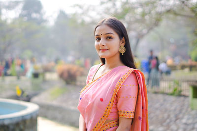 Portrait of woman standing outdoors