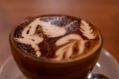 Close-up of cappuccino served on table