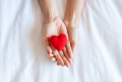 Close-up of woman holding heart shape