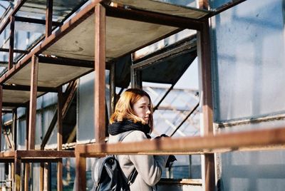 Woman standing under scaffolding