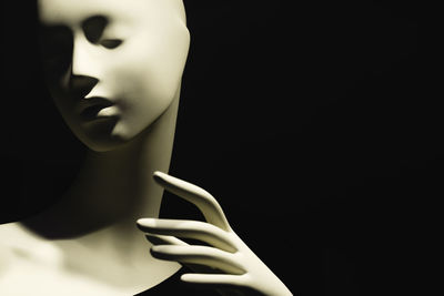 Close-up of mannequin against black background