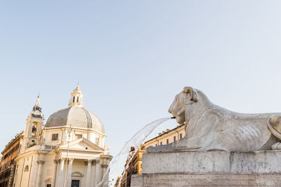 Low angle view of statue of building against clear sky