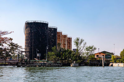 Old fuel storage tank in an industrial area near the river