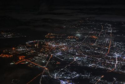 Close-up of illuminated city against sky at night