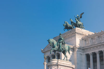 Low angle view of statue against blue sky