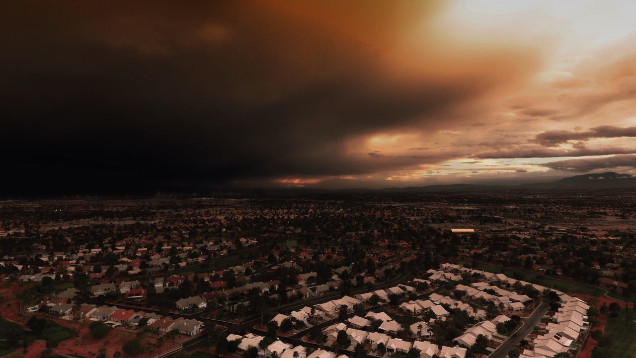 cityscape, aerial view, city, high angle view, building exterior, crowded, architecture, sky, built structure, cloud - sky, residential district, illuminated, landscape, dusk, sunset, residential building, residential structure, cloudy, horizon over land, weather