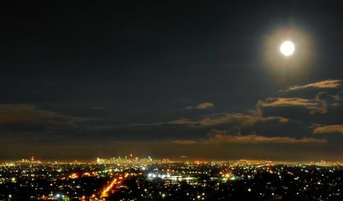 High angle view of illuminated buildings against sky at night