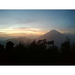 Scenic view of mountains against sky at sunset