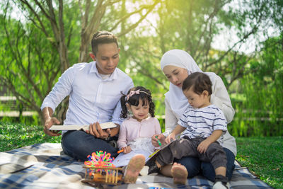 Family spending leisure time in public park