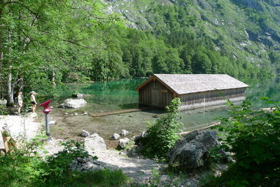 House amidst lake against mountain