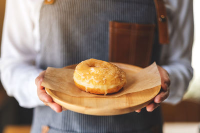 Midsection of man holding food