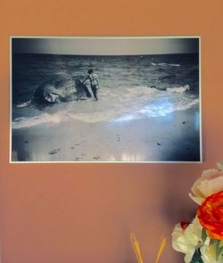 Scenic view of sea and orange sky seen through glass