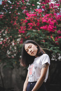 Portrait of woman standing against plants