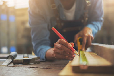Close-up of man working on wood