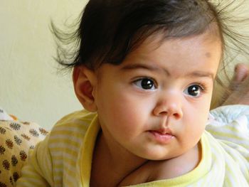 Close-up portrait of cute baby on bed