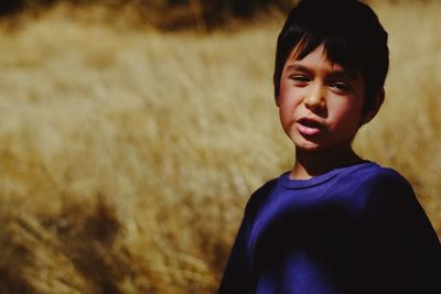 Portrait of boy standing outdoors