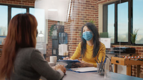 Businesswoman interviewing candidate at desk