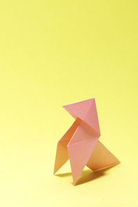 High angle view of paper flag on yellow background