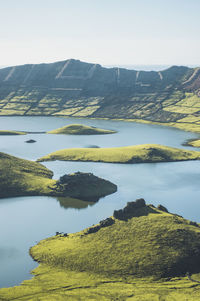 View of mountains and lake on sunny day at corvo island, azores, portugal