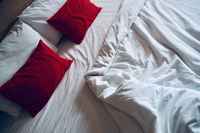 High angle view of pillows and blanket on bed at home