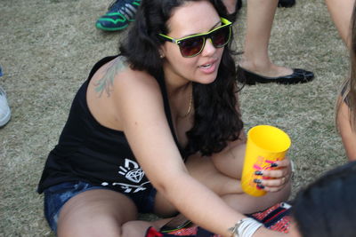 Midsection of woman holding camera on field