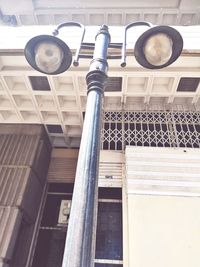 Low angle view of street light against building