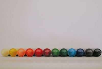 Close-up of multi colored candies against white background
