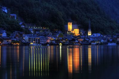 Reflection of buildings in lake at night