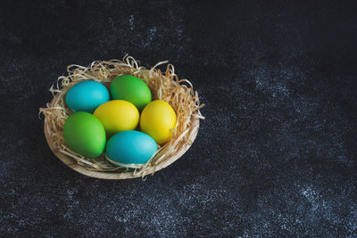 High angle view of multi colored eggs in basket
