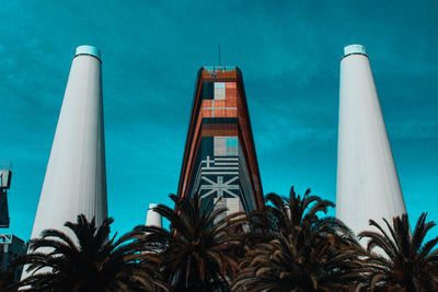 Low angle view of skyscraper against blue sky