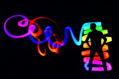 Multi colored light painting against black background