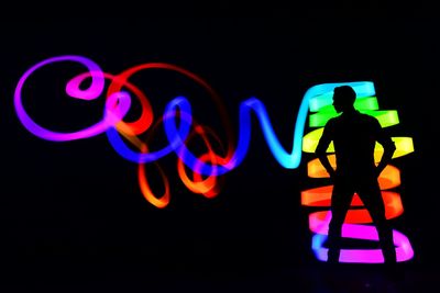 Multi colored light painting against black background