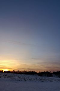 Scenic view of snow against sky during sunset