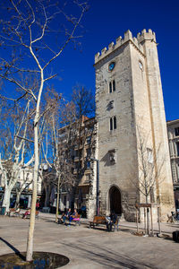 Street by building against blue sky