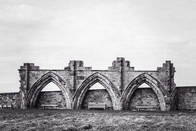 Benches under arches of ruined building