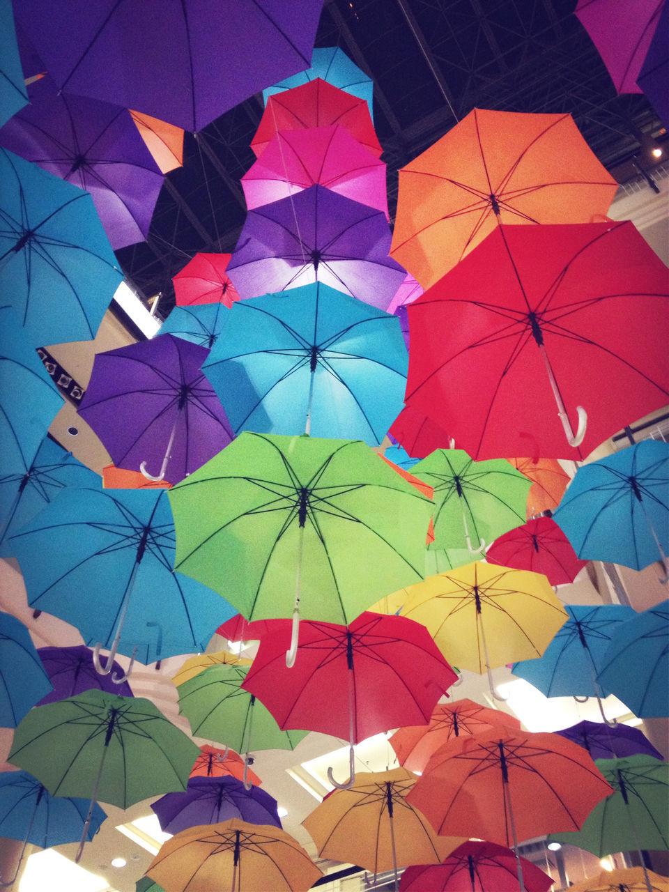 multi colored, umbrella, low angle view, backgrounds, full frame, pattern, protection, colorful, sky, design, day, hanging, decoration, clear sky, blue, outdoors, shape, no people, abundance, parasol