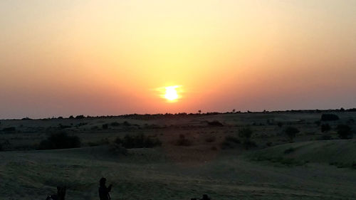 Scenic view of landscape against sky during sunset