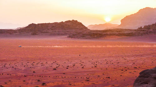 Scenic view of land against sky during sunset