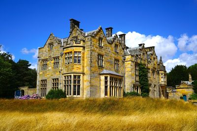 Low angle view of historical building against blue sky