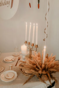 Close-up of illuminated candles on table