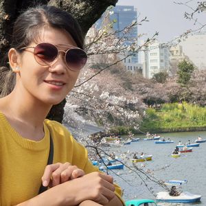 Portrait of woman wearing sunglasses with lake in background