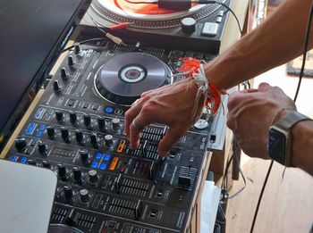 Cropped hands of man mixing sound at studio