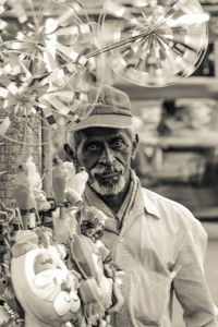 Portrait of man holding bouquet outdoors