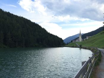 Scenic view of river against cloudy sky