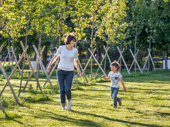 Family life. mother and son play in park. summer vibes. active outdoor game. lifestyle. 