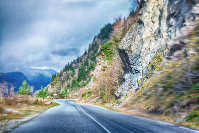 Road amidst rocks against sky