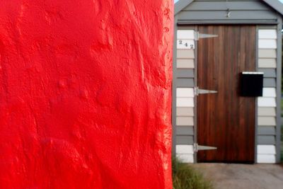 Close-up of red wall against door