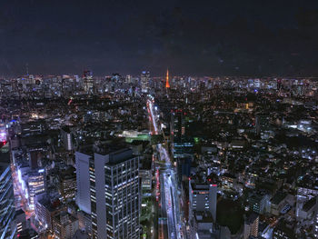 High angle view of illuminated city buildings at night