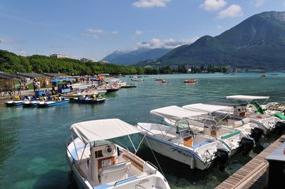 Boats moored in sea against sky