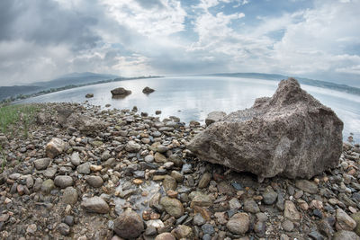 Rocks on beach against sky